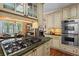Kitchen features a marble countertop, stainless steel appliances, and custom cabinetry at 9860 Hunt Club Way, Johns Creek, GA 30022