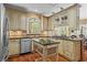 Well-designed kitchen with custom cabinets, a marble countertop, an island, and stainless steel appliances at 9860 Hunt Club Way, Johns Creek, GA 30022