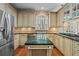 Charming kitchen with an island with marble countertop and stainless steel refrigerator at 9860 Hunt Club Way, Johns Creek, GA 30022