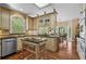 Charming kitchen features custom cabinetry, stainless steel appliances, and a marble topped island at 9860 Hunt Club Way, Johns Creek, GA 30022