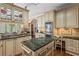 Spacious kitchen boasts an island with marble countertop, stainless steel appliances, and custom cabinetry at 9860 Hunt Club Way, Johns Creek, GA 30022