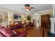Comfortable living room with hardwood floors, a fireplace, and an open view to other spaces at 9860 Hunt Club Way, Johns Creek, GA 30022