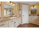 A pristine bathroom with a separate tub and shower, dual sinks, custom cabinets, and granite countertops at 9860 Hunt Club Way, Johns Creek, GA 30022