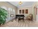 Elegant piano room featuring natural light from windows with plantation shutters at 9860 Hunt Club Way, Johns Creek, GA 30022
