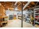 Unfinished basement with exposed wooden beams and storage shelves at 1477 Brawley Ne Cir, Brookhaven, GA 30319