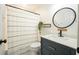 Well-lit bathroom featuring modern vanity, decorative mirror, and neutral color palette at 1477 Brawley Ne Cir, Brookhaven, GA 30319