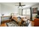 Cozy bedroom with hardwood floors, ceiling fan, window, and stylish decor at 1477 Brawley Ne Cir, Brookhaven, GA 30319