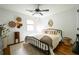 Comfortable bedroom with hardwood floors, ceiling fan, window, and decorative accents at 1477 Brawley Ne Cir, Brookhaven, GA 30319