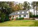 Charming two-story home with a well-maintained lawn and mature trees, offering a picturesque setting at 1477 Brawley Ne Cir, Brookhaven, GA 30319