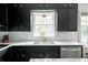 Modern kitchen with sleek black cabinets, stainless steel appliances, and bright countertops at 1477 Brawley Ne Cir, Brookhaven, GA 30319