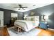 Comfortable main bedroom featuring hardwood floors, ceiling fan, decorative art, and neutral color palette at 1477 Brawley Ne Cir, Brookhaven, GA 30319