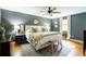 Comfortable main bedroom featuring hardwood floors, ceiling fan, decorative art, and neutral color palette at 1477 Brawley Ne Cir, Brookhaven, GA 30319