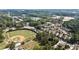 An aerial view shows a community with baseball fields, trees, and residential homes close to local amenities at 201 Saddle Rd, Alpharetta, GA 30009