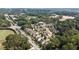 Aerial view of the neighborhood featuring well-placed baseball field and quiet roads amid lush green trees and landscape at 201 Saddle Rd, Alpharetta, GA 30009