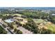 An aerial view shows a baseball field, pool, and parking area, surrounded by trees, providing a recreational community setting at 201 Saddle Rd, Alpharetta, GA 30009