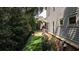 Well-maintained backyard, side view of the house, screened porch, lush greenery at 201 Saddle Rd, Alpharetta, GA 30009