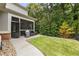 Professionally landscaped backyard with a screened in porch and green lawn at 201 Saddle Rd, Alpharetta, GA 30009