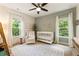 Bright bedroom with large windows, crib, and soft decor at 201 Saddle Rd, Alpharetta, GA 30009