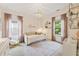 Bedroom room with decorative accents, a crystal chandelier, and large windows that let in tons of natural light at 201 Saddle Rd, Alpharetta, GA 30009