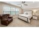 Cozy bedroom featuring a bed, tufted armchair, and natural light at 201 Saddle Rd, Alpharetta, GA 30009
