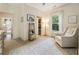 Comfortable bedroom with natural light, sitting chair, and view to hall at 201 Saddle Rd, Alpharetta, GA 30009