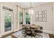 Eat-in kitchen featuring a wooden table with modern chairs, natural light, and view to outside patio at 201 Saddle Rd, Alpharetta, GA 30009