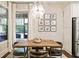 Dining area with a wooden table, unique chairs, natural light, and view to the outdoor patio at 201 Saddle Rd, Alpharetta, GA 30009