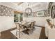 Bright dining room with a large window, tray ceiling, and a modern light fixture at 201 Saddle Rd, Alpharetta, GA 30009
