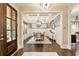 Elegant dining room featuring stylish light fixture, decorative wallpaper, and beautiful hardwood floors at 201 Saddle Rd, Alpharetta, GA 30009