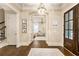 Bright foyer with dark hardwood floors and an open view to the play room at 201 Saddle Rd, Alpharetta, GA 30009