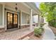 Charming front porch features brick flooring, hanging lights, and inviting double doors at 201 Saddle Rd, Alpharetta, GA 30009