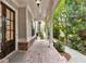 Inviting front porch boasts brick flooring and walkway surrounded by lush greenery at 201 Saddle Rd, Alpharetta, GA 30009
