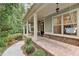 Welcoming front porch showcases brick accents and a charming porch swing at 201 Saddle Rd, Alpharetta, GA 30009