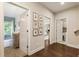 Hallway with hardwood floors, gallery wall, and access to the bedroom, bathroom, and laundry room at 201 Saddle Rd, Alpharetta, GA 30009