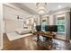Connected home office with a modern chandelier, hardwood floors, desk with dual monitors and lots of natural light at 201 Saddle Rd, Alpharetta, GA 30009