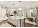 Open concept kitchen features large island with white countertops and stainless steel appliances at 201 Saddle Rd, Alpharetta, GA 30009