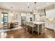 Open kitchen design with stainless steel appliances and custom lighting at 201 Saddle Rd, Alpharetta, GA 30009