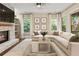 Inviting living room showcasing a stone fireplace and light-filled with a neutral decor at 201 Saddle Rd, Alpharetta, GA 30009