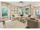 Cozy living room showcasing a stone fireplace, a large sectional, and natural light at 201 Saddle Rd, Alpharetta, GA 30009