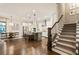 Open floorplan view from the living room showing the kitchen, dining area and the stairway to the upper floor at 201 Saddle Rd, Alpharetta, GA 30009