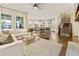 Open-concept living room and kitchen with hardwood floors, comfortable seating, and natural light at 201 Saddle Rd, Alpharetta, GA 30009