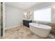 Comfortable main bathroom with separate tub and glass shower, double vanity, and tile flooring at 201 Saddle Rd, Alpharetta, GA 30009