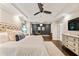 Luxurious main bedroom featuring hardwood floors, tray ceilings, and a connected home office with lots of light at 201 Saddle Rd, Alpharetta, GA 30009