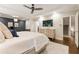 Spacious main bedroom boasts hardwood floors, tray ceilings, and ensuite bath with a view to the staircase at 201 Saddle Rd, Alpharetta, GA 30009