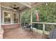 Inviting screened porch with ceiling fan, table and chairs, overlooking the green yard at 201 Saddle Rd, Alpharetta, GA 30009