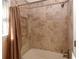 Tiled shower and tub combination in a remodeled bathroom with neutral tones at 2815 Cambridge Hills Rd, Cumming, GA 30041