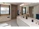 Bathroom featuring dual sink vanity, jacuzzi tub, tiled shower, and lots of natural light at 2815 Cambridge Hills Rd, Cumming, GA 30041
