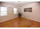 Bright bedroom with hardwood floors, multiple windows, and charming wall decor at 2815 Cambridge Hills Rd, Cumming, GA 30041