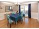 Elegant dining room with wood floors, a chandelier, and blue upholstered chairs at 2815 Cambridge Hills Rd, Cumming, GA 30041