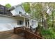 Rear exterior view of a two-story home with a deck and sunroom at 2815 Cambridge Hills Rd, Cumming, GA 30041